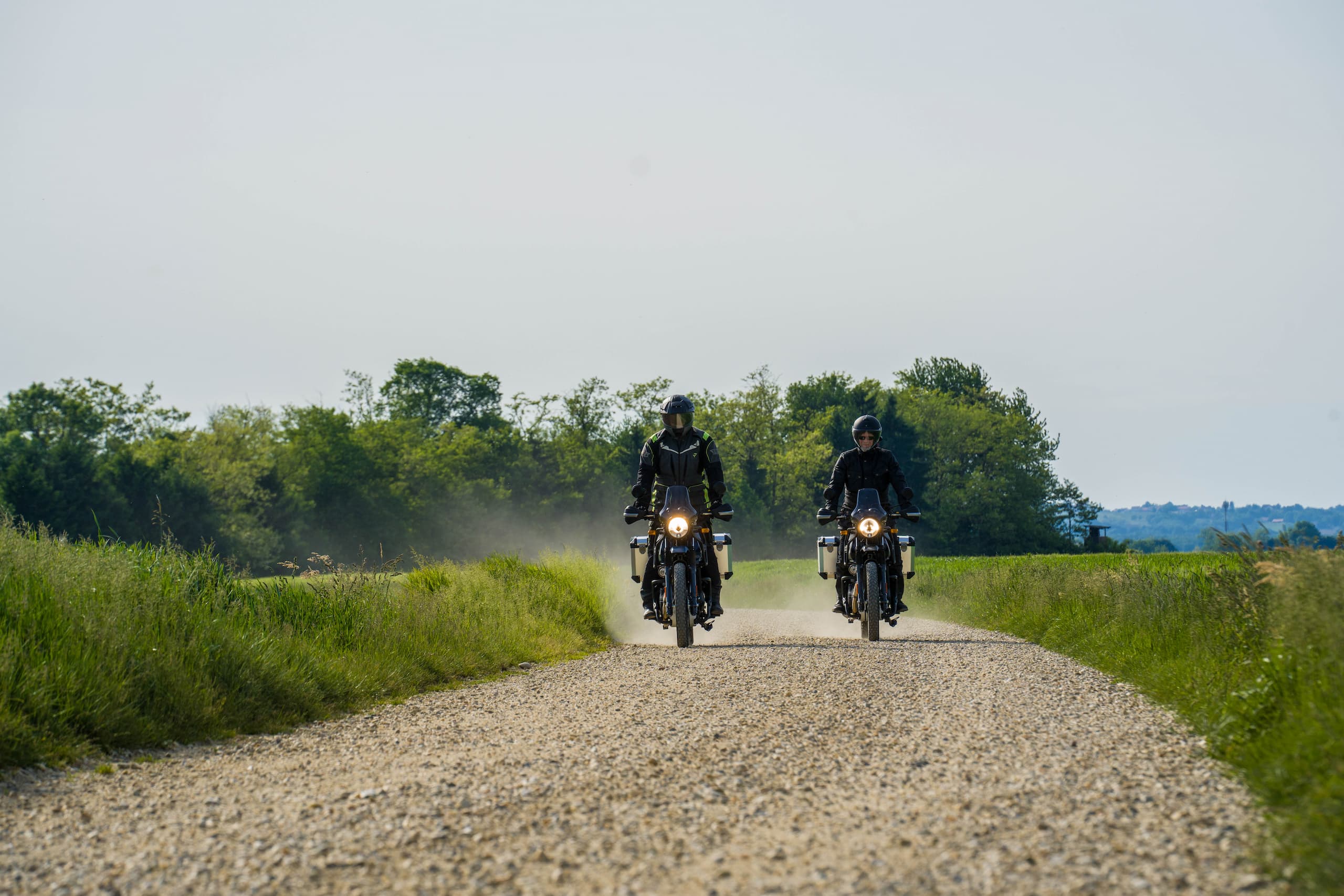 2 Men riding royal enfield motorcycles towards the camera