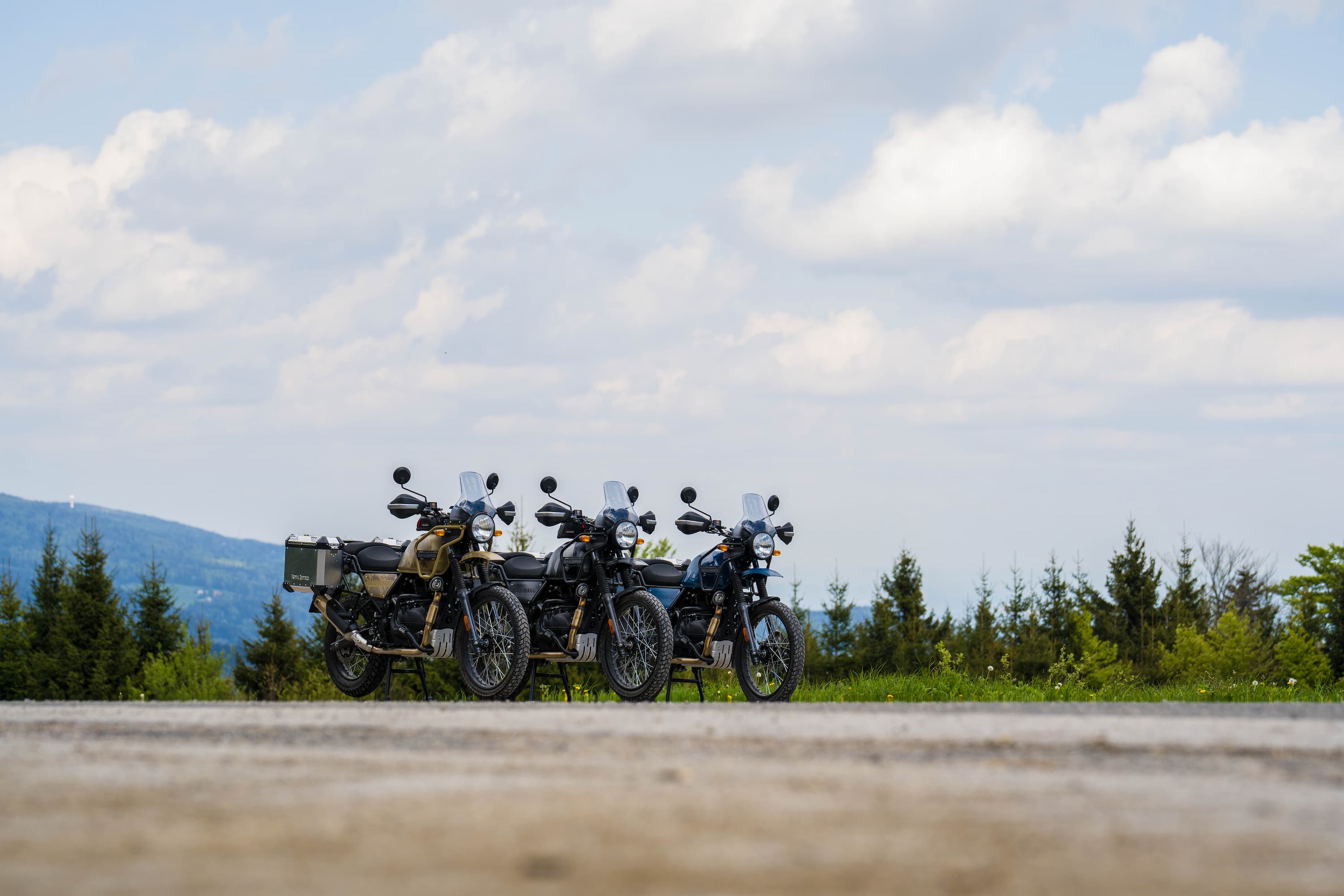 3 royal enfield motorcycles beside each other